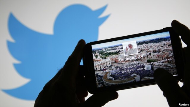 Pope Benedict XVI's Twitter account pictured on a smartphone.