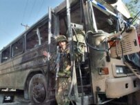 A bus that hit a roadside bomb in Kabul in May (AFP)