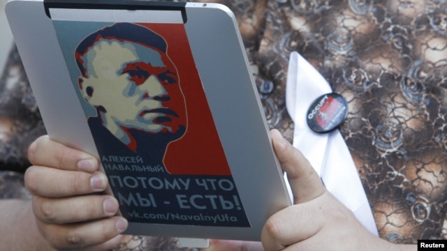 An opposition activist uses an electronic device with a portrait of prominent anticorruption blogger Aleksei Navalny during a protest in central Moscow last week.
