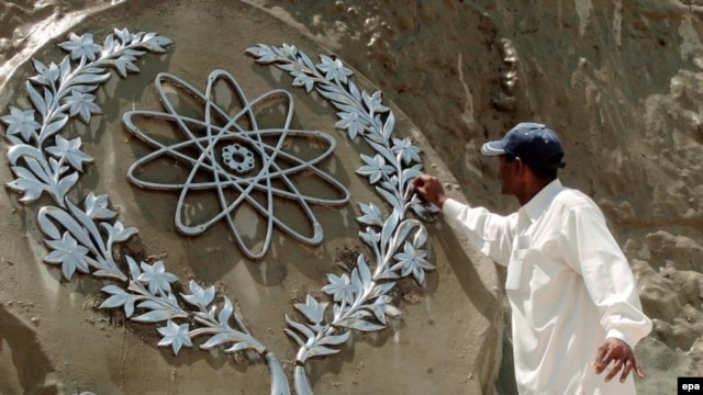 A worker in Islamabad cleans a bas-relief of the Chaghi Mountains, where Pakistan conducted its atomic explosions in 1998.