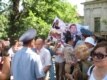 Полицейские отбирают плакаты у участников акции протеста.