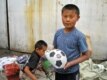 A boy from Kyrgyzstan at the central market in neighboring Kazakhstan\'s second city, Almaty, where he says he earns 200 tenges (about $1.20) for every container of goods he moves (RFE/RL)