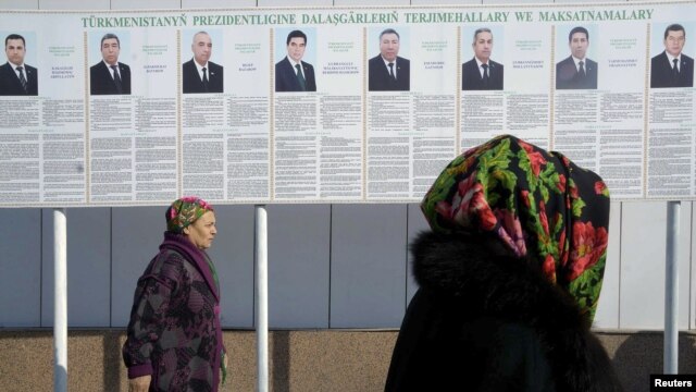 A billboard in the capital, Ashgabat, displays the portraits and biographies of the country's eight presidential candidates.