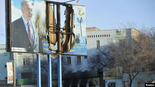 A billboard featuring President Nursultan Nazarbaev was damaged during the violence in the town of Zhanaozen.