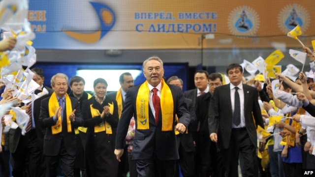 President Nursultan Nazarbaev's supporters greet him (center) as he arrives for a celebration rally at a sports center in Astana on April 4.