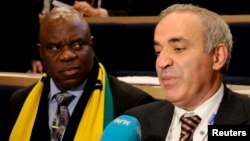 Garry Kasparov (right) answers questions from reporters after he lost the election to head the World Chess Federation in Norway on August 11.