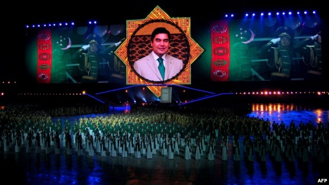 A massive portrait of Berdymukhammedov looms over attendees at an inauguration ceremony for the Palace of Happiness wedding complex in Ashgabat in October 2011.