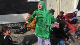 Injured women and young girls cry near the dead and injured from the Kabul explosion.