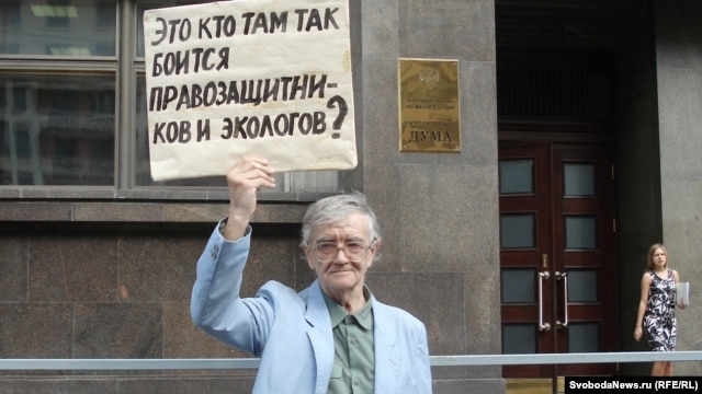 A supporter of the opposition Yabloko party protests against the NGO bill in front of the State Duma in Moscow on July 6. His sign reads, "Who is it in there who's so afraid of rights activists and ecologists?"