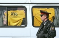 Greenpeace activists being taken away from Red Square (ITAR-TASS)