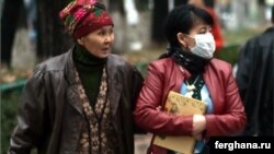 People wear protective masks against swine flu in Bishkek earlier this month.