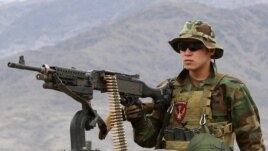 A Special Forces member from the Afghan National Army mans a machine gun on an armored vehicle while leaving for a mission with U.S. Special Forces soldiers in Kunar Province on March 12.
