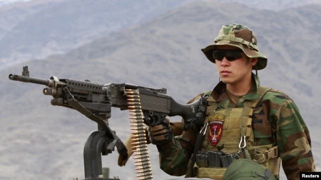 A Special Forces member from the Afghan National Army mans a machine gun on an armored vehicle while leaving for a mission with U.S. Special Forces soldiers in Kunar Province on March 12.