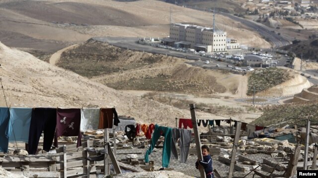 A Palestinian girl stands in an area near Jerusalem known as E1, where there are plans by Israel for the construction of some 3,000 settlers' homes.