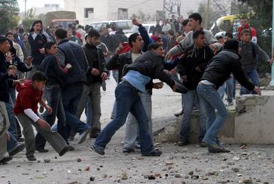 Palestinians attacking the mission in Hebron on 8 February