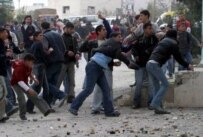 Palestinians attacking the mission in Hebron on 8 February (epa)