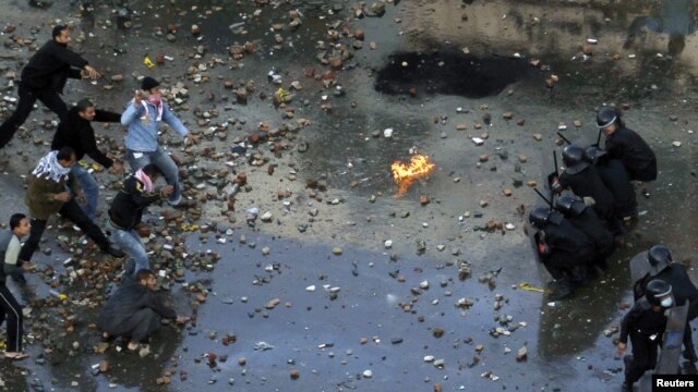 Antigovernment protesters clash with riot police at the Egyptian port city of Suez on January 27.