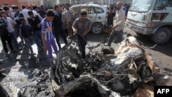 Iraqis inspect the site of a car bomb attack in Baghdad's impoverished district of Sadr City on February 17.