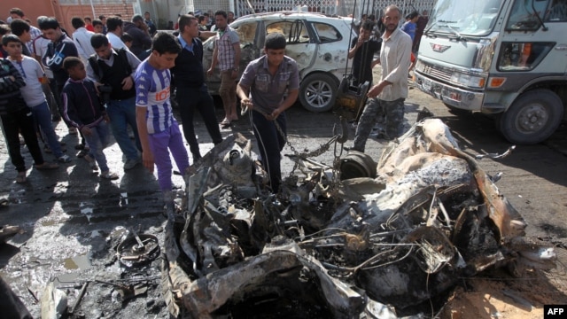 Iraqis inspect the site of a car bomb attack in Baghdad's impoverished district of Sadr City on February 17. 