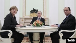 German Chancellor Angela Merkel (left to right), Russian President Vladimir Putin, and French President Francois Hollande are pictured during a meeting in the Kremlin, in Moscow, on February 6.