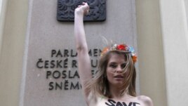 In what she describes as a "cry of despair," Hagen protested topless in front of the Czech parliament building earlier this month.