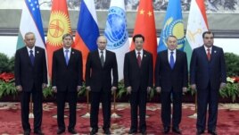 Shanghai Cooperation Organization leaders pose for a photo at a summit in Beijing in June.