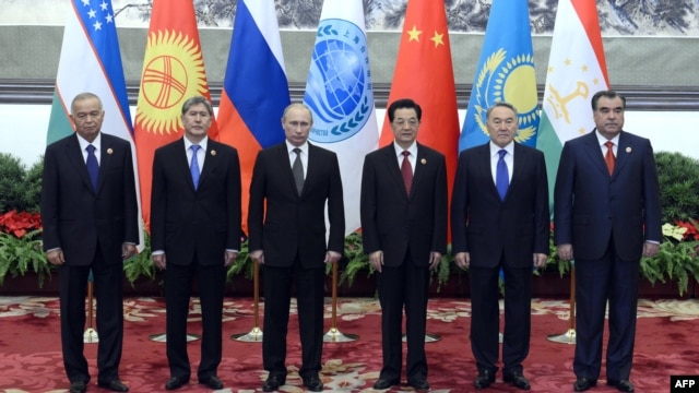 Shanghai Cooperation Organization leaders pose for a photo at a summit in Beijing in June.