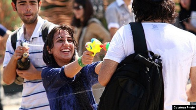 Young people fight with water guns in a park in Tehran last month.