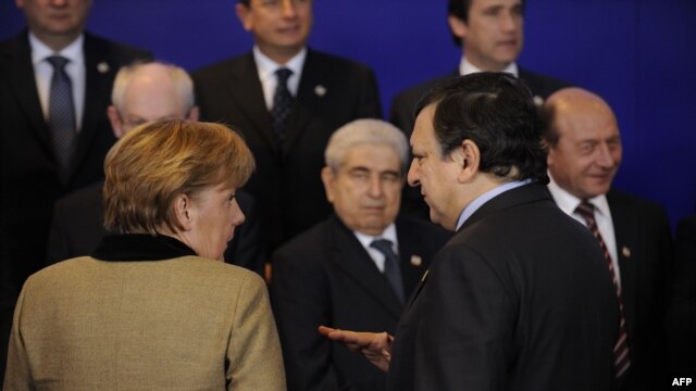 German Chancellor Angela Merkel (left) and European Commission President Jose Manuel Barroso speak prior to a photo opportunity during a European Union summit at EU headquarters in Brussels in January.