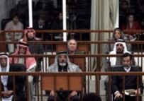 Hussein (front right) and his fellow defendants in court on 29 January (epa)