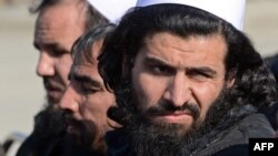 Freed Taliban prisoners sit on chairs as they listen to speeches during a ceremony to mark their release in Pul-e-Charkhi jail on the outskirts of Kabul on January 4.