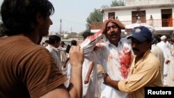 A man cries over the death of his brother at the site of a suicide blast at a church in Peshawar on September 22.