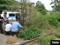 Investigators at the site of a June 29 blast at Gagry
