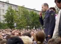 A police officer tries to calm a crowd in Kondopoga on September 3 (TASS)