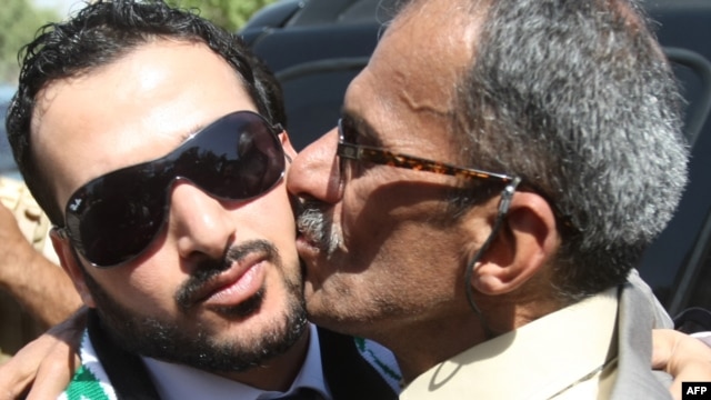 Muntadhar al-Zaidi (left) is welcomed by supporters in Baghdad after his release from prison in September 2009.