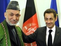 Afghan President Hamid Karzai (right) meets with French President Nicolas Sarkozy at the NATO summit in Bucharest (AFP)