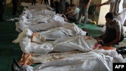 Egyptians mourn over bodies at a mosque in Cairo on August 16 after clashes broke out during a demonstration in support of Egypt's ousted President Muhammad Morsi.