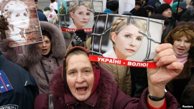 A supporter of jailed opposition leader Yulia Tymoshenko holds up a picture of her during a rally in front of the Appeals Court building in Kyiv last week.
