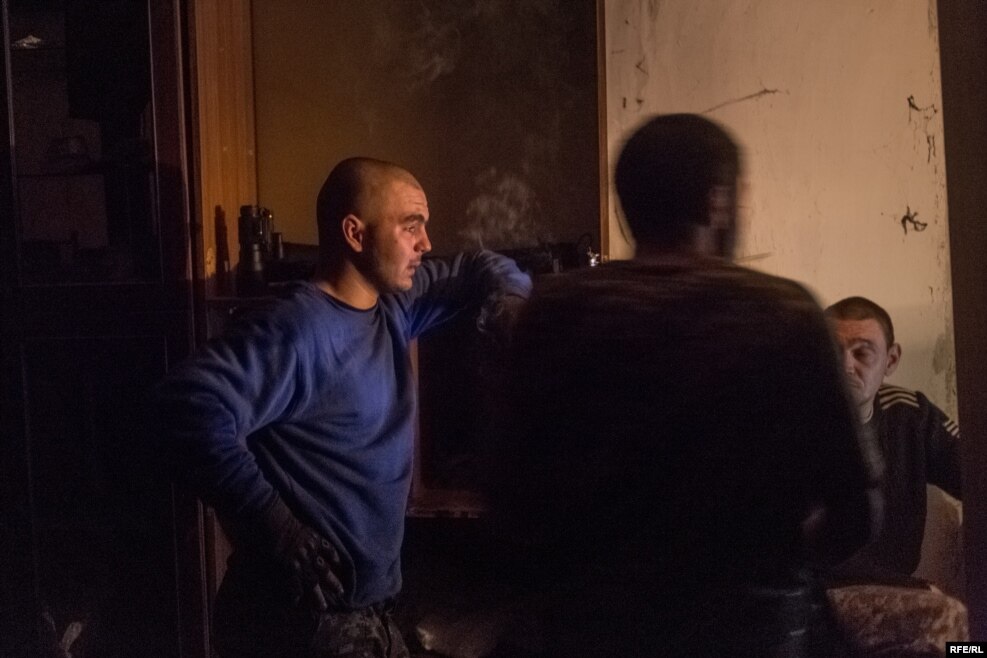 On the left is "Little One," a servicemen in Ukraine's official armed forces, whose commander housed him with the volunteers. Days after this picture was taken, Little One was wounded in battle and will now spend two months in the hospital. He was a week away from being demobilized.