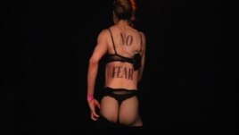 Madonna stripped down to reveal "No Fear" written on her bare back.