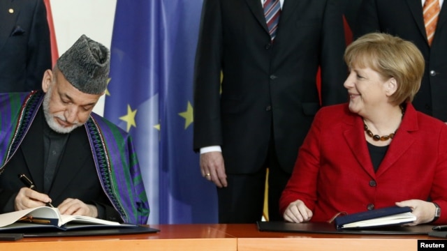 German Chancellor Angela Merkel (right) with Afghan President Hamid Karzai in Berlin. 