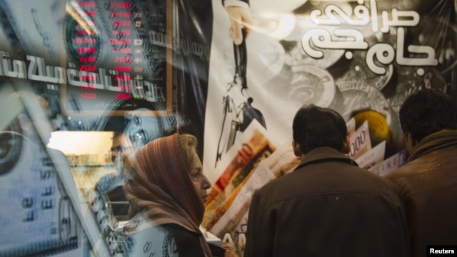 A woman stands in a currency exchange shop in northern Tehran on January 3.