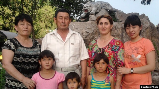 Absattar Myrzabekov poses with his second (Fatima, left)  and third wives (Kulaihan, second right) and their children. His first wife says she's "happy to share."