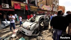 People gather at the scene of the car-bomb explosion outside a hospital in Benghazi, Libya on May 13.