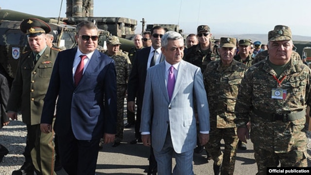 Armenia - President Serzh Sarkisian and Russian Defense Minister Anatoly Serdyukov (L) monitor CSTO military exercises at the Marshal Bagramian training ground, 19Sep2012.
