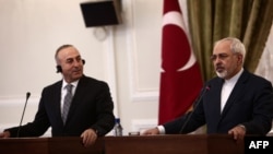 Turkish Foreign Minister Mevlut Cavusoglu (left) made his remarks after meeting his Iranian counterpart Mohammad Javad Zarif (right) in Ankara. (file photo)