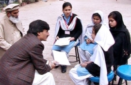 Khyber-Pakhtunkhwa Education Minister Sardar Babak (left) meeting with school girls