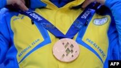 The athletes covered their medals as a gesture in protest at the turmoil in their country.