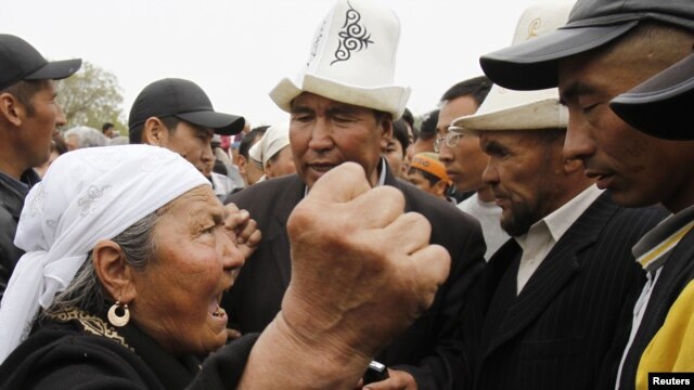 A supporter of President Kurmanbek Bakiev (left) argues with interim government followers attempting to hold a rally at the central square in Jalal-Abad on April 14.
