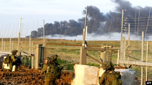 Israeli soldiers cross the border into the Gaza Strip.